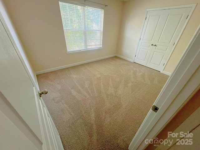 11624 Truan Ln, Cornelius, NC 28031 - unfurnished bedroom with carpet flooring, baseboards, and a closet