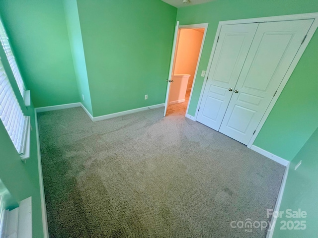 11624 Truan Ln, Cornelius, NC 28031 - unfurnished bedroom featuring carpet flooring, baseboards, and a closet