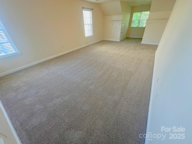 11624 Truan Ln, Cornelius, NC 28031 - empty room featuring baseboards, plenty of natural light, carpet floors, and vaulted ceiling