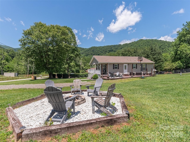 16 Sams Branch Rd, Candler, NC 28715 - view of grassy yard featuring a fire pit, a patio area, and a forest view