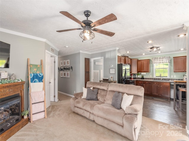 16 Sams Branch Rd, Candler, NC 28715 - living area with ceiling fan, crown molding, a textured ceiling, a fireplace, and recessed lighting