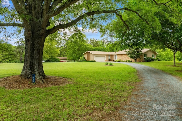 2309 Potter Rd S, Waxhaw, NC 28173 - single story home featuring a front lawn, a garage, stucco siding, and driveway