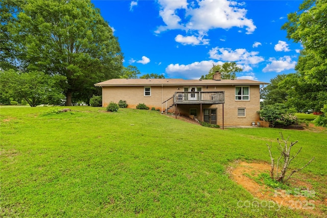 2309 Potter Rd S, Waxhaw, NC 28173 - back of property with a wooden deck, a lawn, stairs, and a chimney