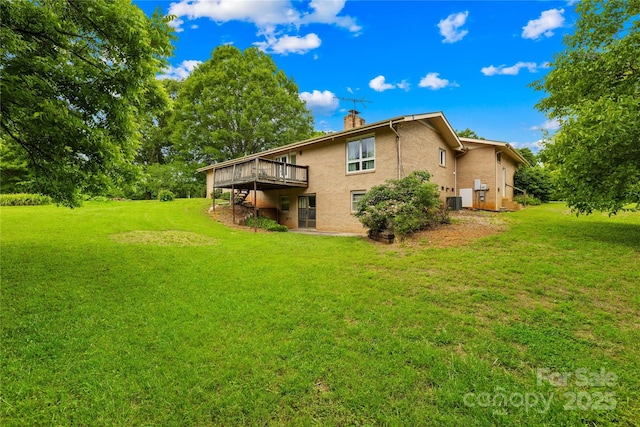 2309 Potter Rd S, Waxhaw, NC 28173 - rear view of house with a chimney, a wooden deck, a lawn, and stucco siding