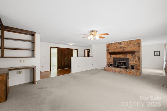 2309 Potter Rd S, Waxhaw, NC 28173 - unfurnished living room with a ceiling fan, carpet flooring, and a stone fireplace