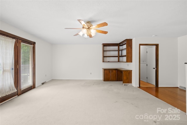 2309 Potter Rd S, Waxhaw, NC 28173 - unfurnished living room with ceiling fan, carpet flooring, and baseboards