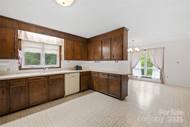 2309 Potter Rd S, Waxhaw, NC 28173 - kitchen with dishwasher, a sink, light countertops, a chandelier, and a peninsula