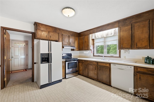 2309 Potter Rd S, Waxhaw, NC 28173 - kitchen with white appliances, a sink, under cabinet range hood, and light countertops