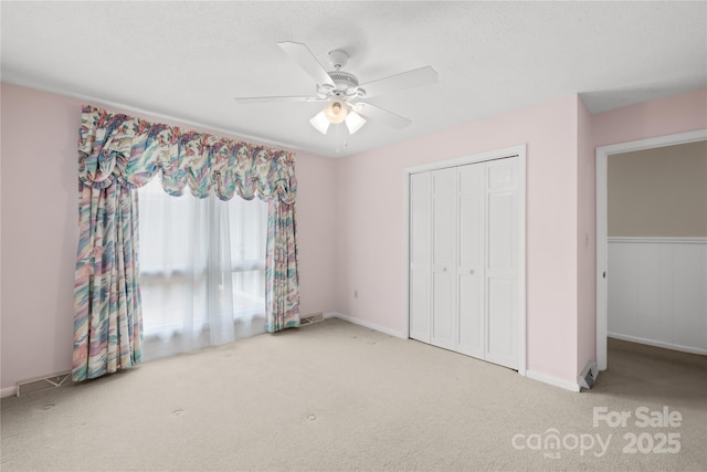 2309 Potter Rd S, Waxhaw, NC 28173 - unfurnished bedroom featuring carpet floors, a closet, a ceiling fan, baseboards, and a textured ceiling