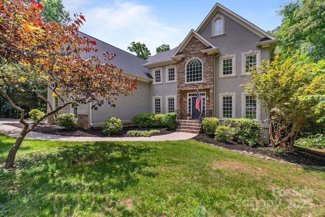 2006 Sandy Pond Ln, Waxhaw, NC 28173 - colonial inspired home with stone siding, stucco siding, and a front yard