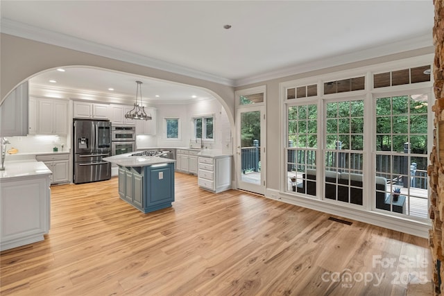 2006 Sandy Pond Ln, Waxhaw, NC 28173 - kitchen featuring stainless steel appliances, arched walkways, white cabinets, a sink, and light countertops