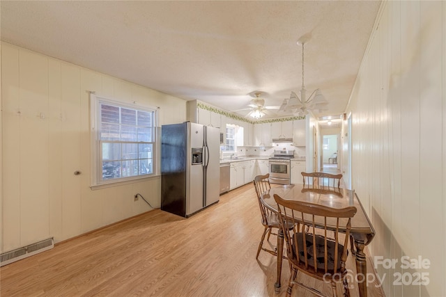 5840 Potter Rd, Matthews, NC 28104 - dining area with ceiling fan, light wood-type flooring, and a textured ceiling