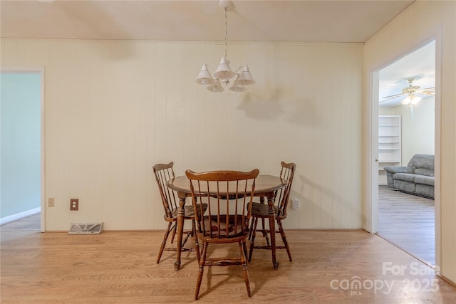 5840 Potter Rd, Matthews, NC 28104 - dining room featuring a chandelier, wood finished floors, and baseboards