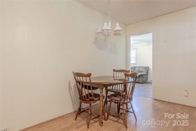 5840 Potter Rd, Matthews, NC 28104 - dining area featuring wood finished floors and a chandelier