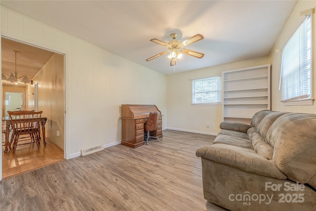 5840 Potter Rd, Matthews, NC 28104 - living area with ceiling fan, wood finished floors, and baseboards