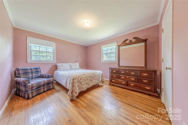 5840 Potter Rd, Matthews, NC 28104 - bedroom featuring light wood-style flooring, crown molding, and baseboards