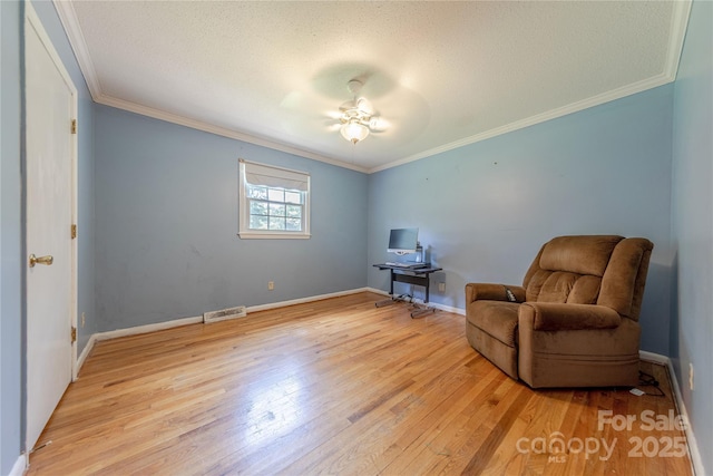 5840 Potter Rd, Matthews, NC 28104 - living area featuring light wood-style floors, ornamental molding, baseboards, ceiling fan, and a textured ceiling