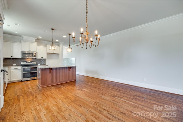 750 Waterscape Ct, Rock Hill, SC 29730 - kitchen with appliances with stainless steel finishes, crown molding, a kitchen breakfast bar, tasteful backsplash, and white cabinetry