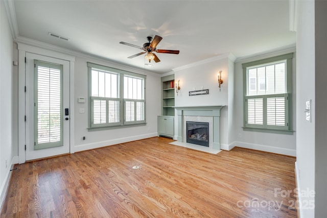 750 Waterscape Ct, Rock Hill, SC 29730 - unfurnished living room with a ceiling fan, healthy amount of natural light, ornamental molding, a fireplace with flush hearth, and wood finished floors