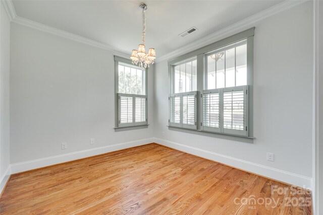 750 Waterscape Ct, Rock Hill, SC 29730 - empty room with ornamental molding, a chandelier, baseboards, and light wood-style flooring