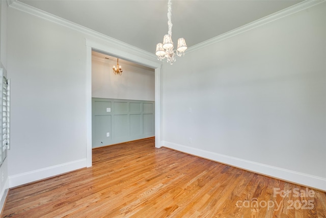 750 Waterscape Ct, Rock Hill, SC 29730 - spare room with a chandelier, crown molding, light wood-style floors, baseboards, and a decorative wall