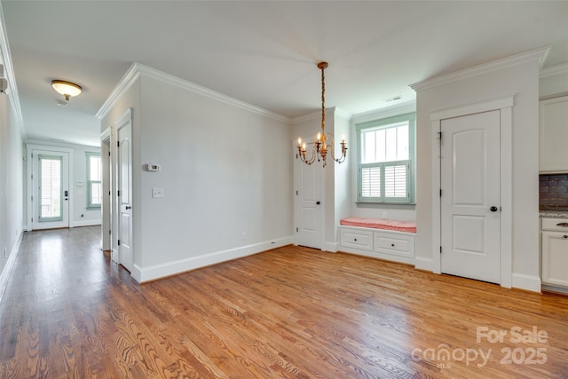 750 Waterscape Ct, Rock Hill, SC 29730 - unfurnished dining area featuring crown molding, light wood-style flooring, a chandelier, healthy amount of natural light, and baseboards