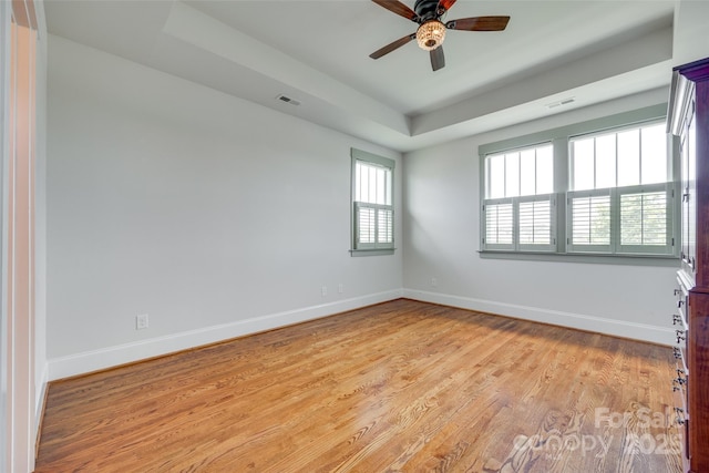 750 Waterscape Ct, Rock Hill, SC 29730 - empty room featuring a tray ceiling, light wood finished floors, ceiling fan, and baseboards
