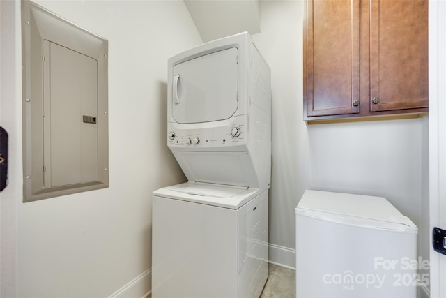 750 Waterscape Ct, Rock Hill, SC 29730 - washroom featuring stacked washing machine and dryer, electric panel, cabinet space, and baseboards