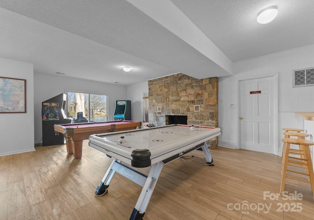 5153 Glenwood St, Sherrills Ford, NC 28673 - recreation room featuring light wood-style flooring, billiards, a textured ceiling, a fireplace, and baseboards