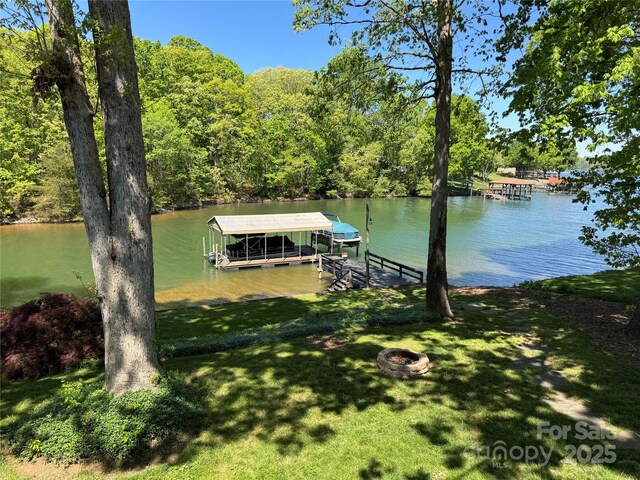 5153 Glenwood St, Sherrills Ford, NC 28673 - dock area featuring a water view, an outdoor fire pit, boat lift, a wooded view, and a yard