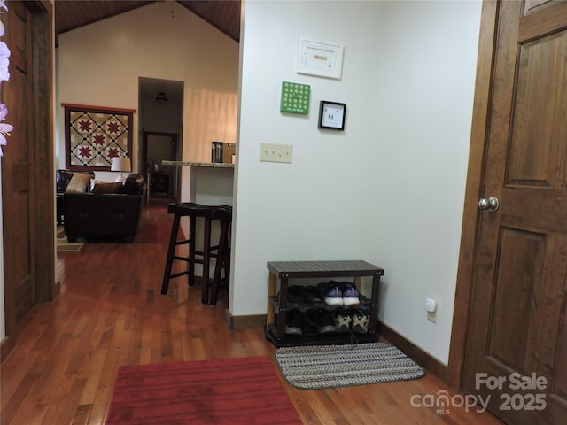 235 Red Oak Ln, Burnsville, NC 28714 - hallway with dark wood finished floors, baseboards, and lofted ceiling