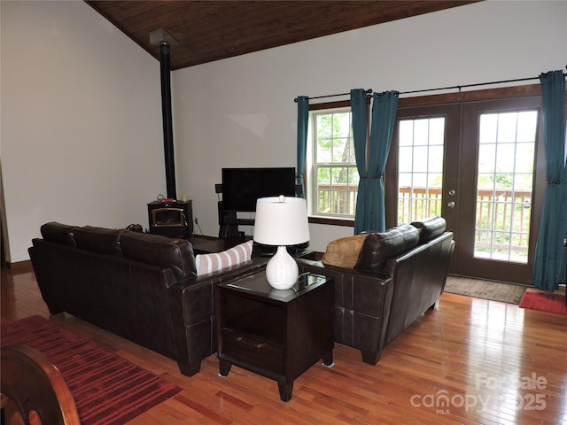 235 Red Oak Ln, Burnsville, NC 28714 - living area featuring light wood-style floors, plenty of natural light, a wood stove, lofted ceiling, and french doors