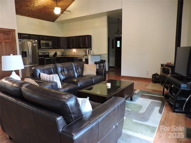 235 Red Oak Ln, Burnsville, NC 28714 - living room featuring wooden ceiling, wood finished floors, high vaulted ceiling, and baseboards