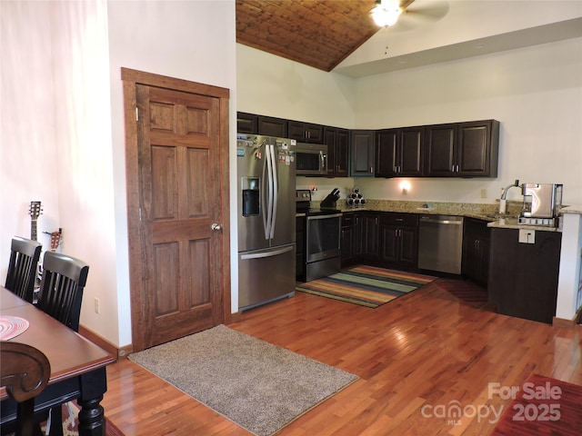 235 Red Oak Ln, Burnsville, NC 28714 - kitchen featuring appliances with stainless steel finishes, light wood finished floors, high vaulted ceiling, a ceiling fan, and light stone countertops