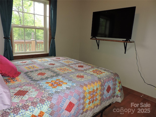 235 Red Oak Ln, Burnsville, NC 28714 - bedroom with baseboards and wood finished floors