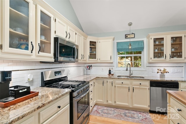 20 Grove Garden Ave, Candler, NC 28715 - kitchen with appliances with stainless steel finishes, a sink, lofted ceiling, decorative backsplash, and light stone counters