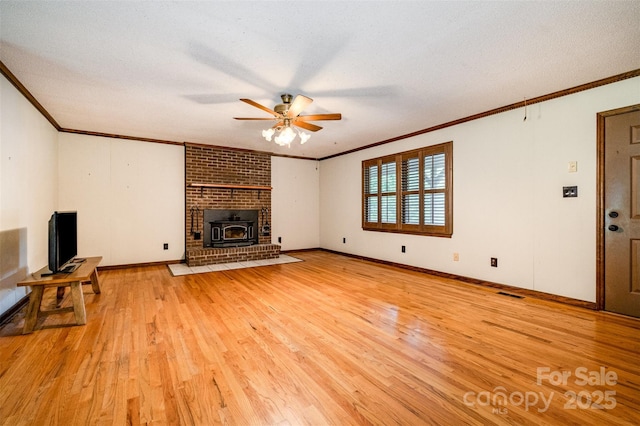 1142 Foxberry Rd, Lincolnton, NC 28092 - unfurnished living room featuring crown molding, ceiling fan, light wood-style flooring, baseboards, and a textured ceiling