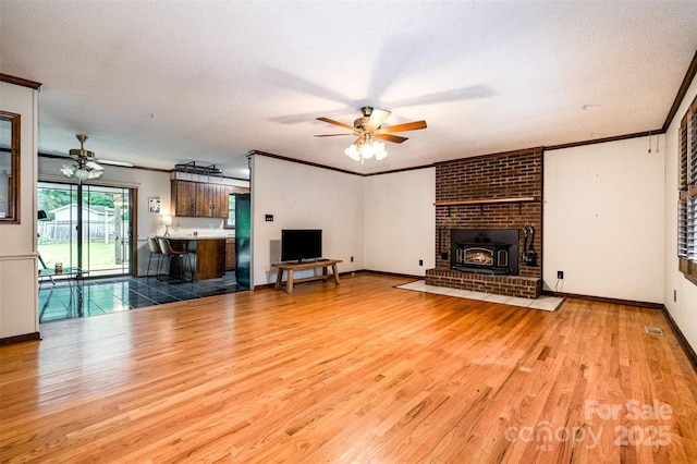 1142 Foxberry Rd, Lincolnton, NC 28092 - unfurnished living room featuring a ceiling fan, wood finished floors, ornamental molding, baseboards, and a textured ceiling
