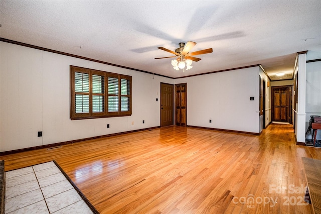 1142 Foxberry Rd, Lincolnton, NC 28092 - spare room with light wood-style floors, a ceiling fan, ornamental molding, a textured ceiling, and baseboards
