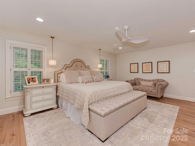 4201 Quail Hunt Ln, Charlotte, NC 28226 - bedroom featuring multiple windows, baseboards, light wood-style floors, and recessed lighting
