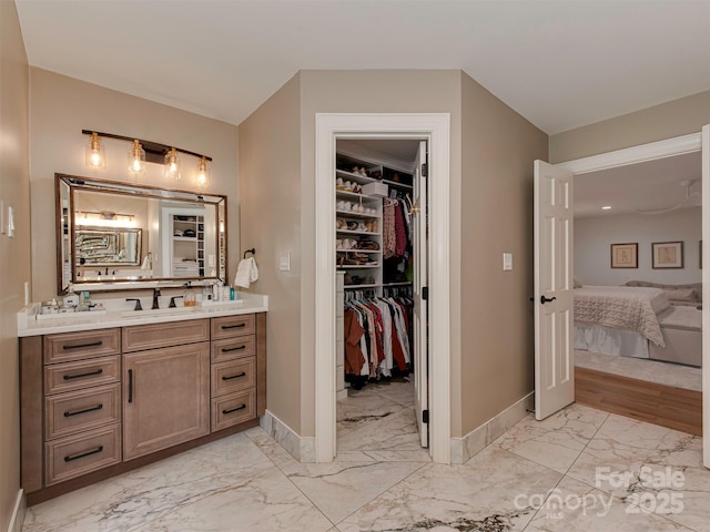 4201 Quail Hunt Ln, Charlotte, NC 28226 - ensuite bathroom featuring marble look tile flooring, vanity, baseboards, and a walk in closet