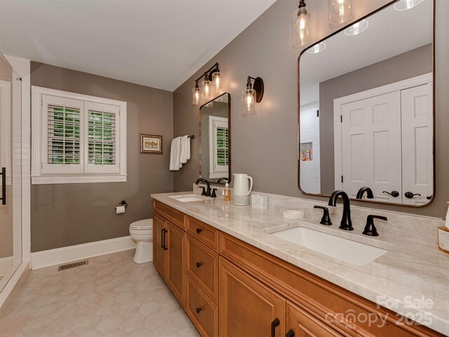 4201 Quail Hunt Ln, Charlotte, NC 28226 - bathroom with double vanity, tile patterned flooring, baseboards, toilet, and a shower with shower door