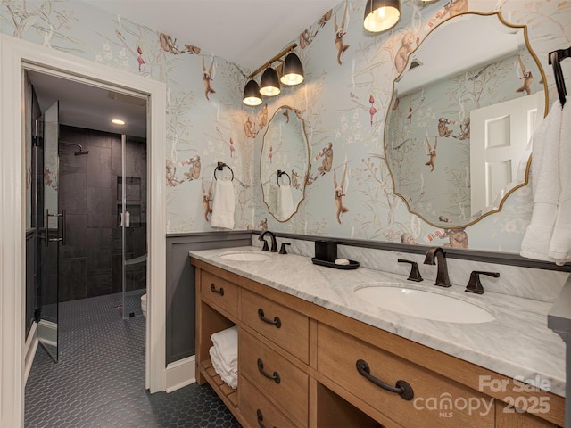 4201 Quail Hunt Ln, Charlotte, NC 28226 - bathroom featuring wallpapered walls, double vanity, a stall shower, a wainscoted wall, and toilet