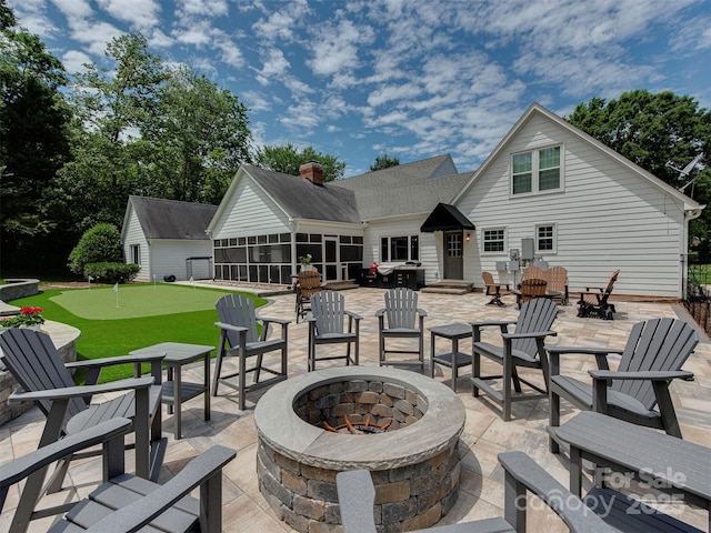 4201 Quail Hunt Ln, Charlotte, NC 28226 - view of patio / terrace featuring a fire pit, a putting green, and a sunroom
