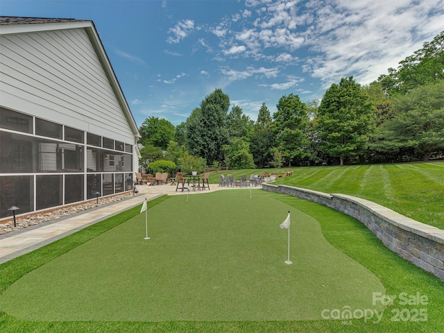 4201 Quail Hunt Ln, Charlotte, NC 28226 - surrounding community with an area to practice putting, view of scattered trees, a patio, and a lawn