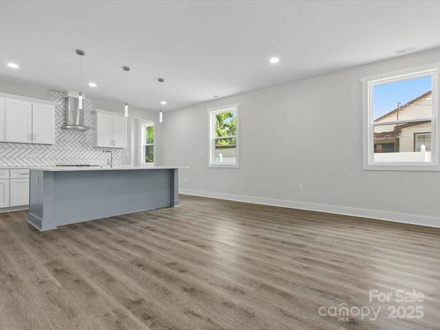 1016 Confederate Ave S, Rock Hill, SC 29732 - kitchen with wall chimney exhaust hood, tasteful backsplash, recessed lighting, white cabinets, and wood finished floors