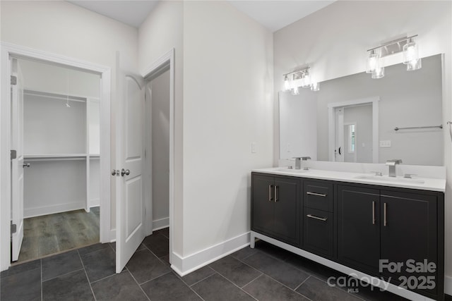 1016 Confederate Ave S, Rock Hill, SC 29732 - bathroom with double vanity, a walk in closet, tile patterned flooring, and baseboards