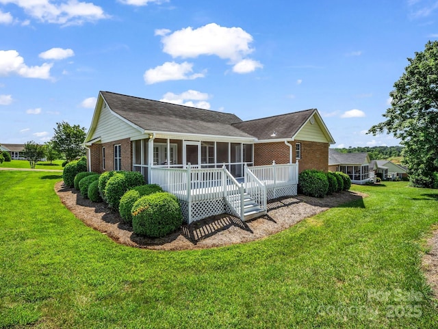 116 Memphis Way, Spindale, NC 28160 - view of front facade featuring brick siding, a sunroom, a front lawn, and a shingled roof