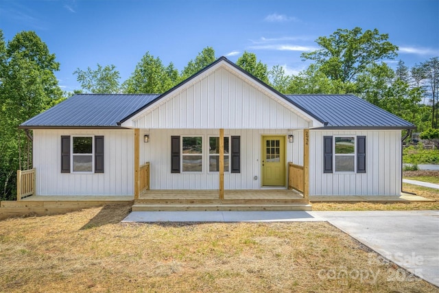 2934 Drummond St, Connelly Springs, NC 28612 - modern farmhouse style home featuring a porch, metal roof, and a front yard