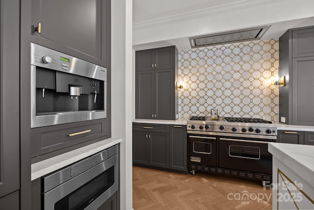 1625 Bibury Ln, Charlotte, NC 28211 - kitchen with appliances with stainless steel finishes, ornamental molding, gray cabinetry, light stone countertops, and tasteful backsplash